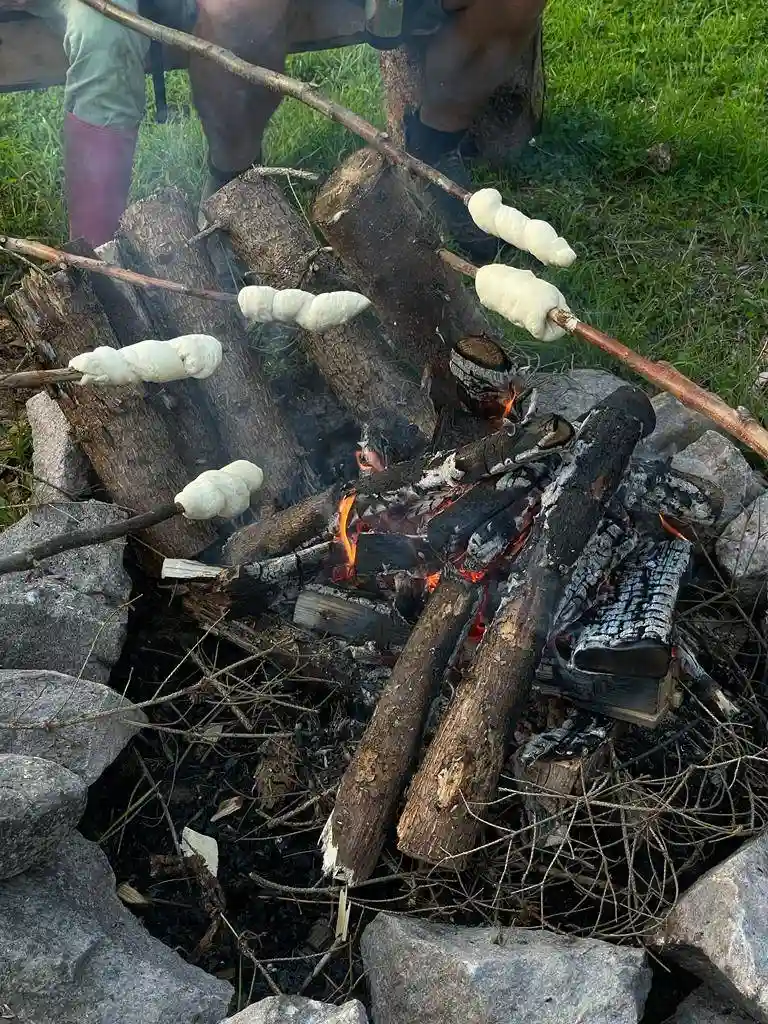 Bild på ett rustikt matbord fyllt med olika matråvaror som kött, grönsaker och andra produkter, redo för tillagning på Pionjärgården.