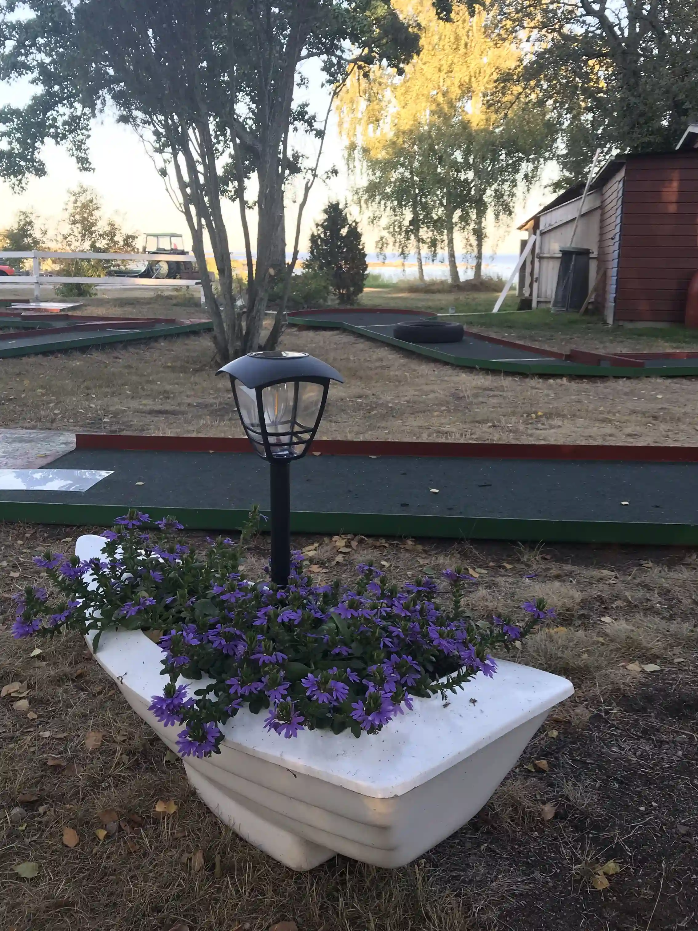 En välskött blomsterträdgård vid Björkenäs camping, med blomkrukor och grönskande växter i en harmonisk utomhusmiljö.