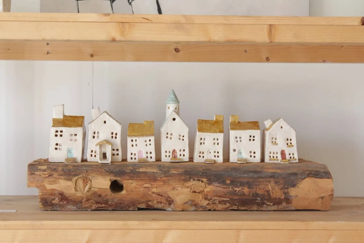 En närbild av olika träelement som representerar inredningen i Pionjärgården, med träplankor och träblock i naturliga nyanser som framhäver materialets struktur och finish.